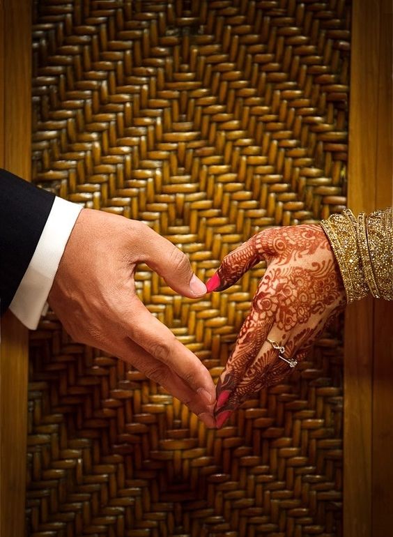 The Couple Making Heart Pose With Their Hands